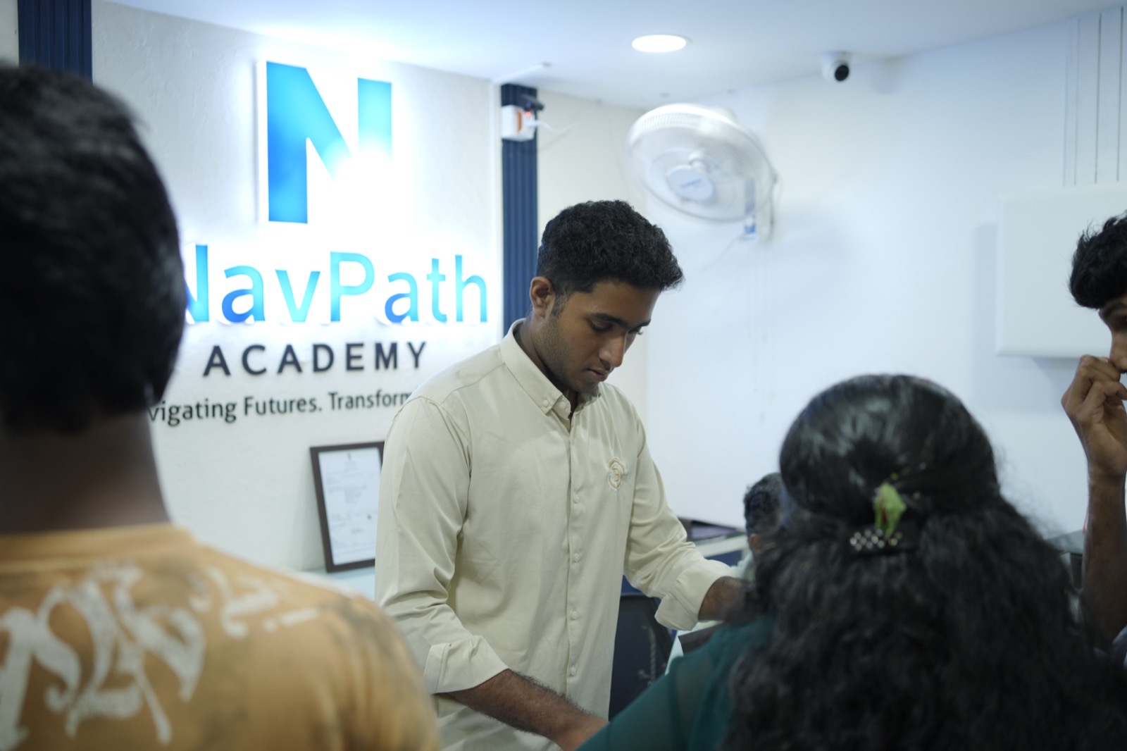 The NavPath Academy reception in Kottayam: the brand wall, a nautical chart and a globe