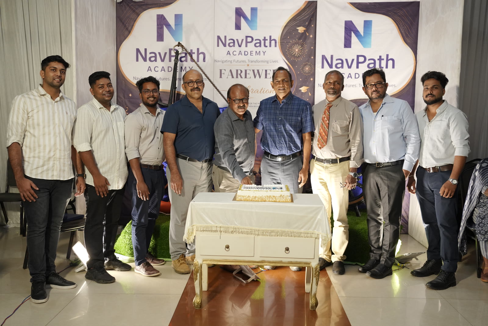 Management and Merchant Navy captains at a NavPath Academy cake cutting
