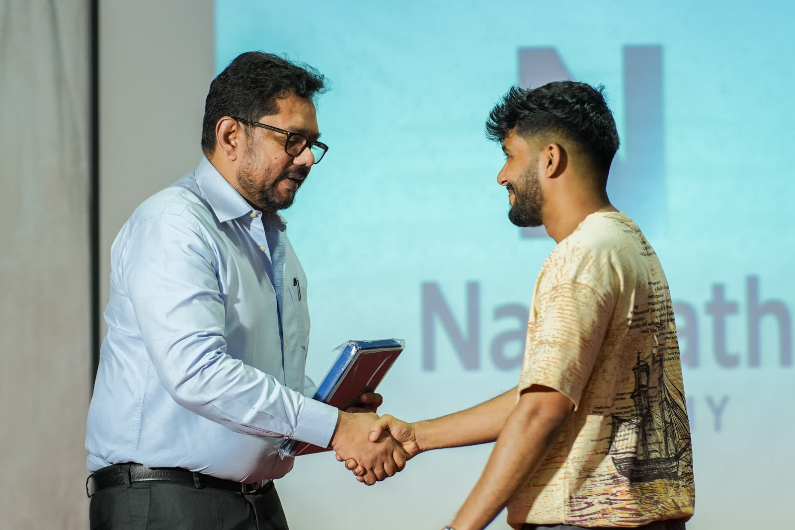 Mentor and student handshake at NavPath Academy
