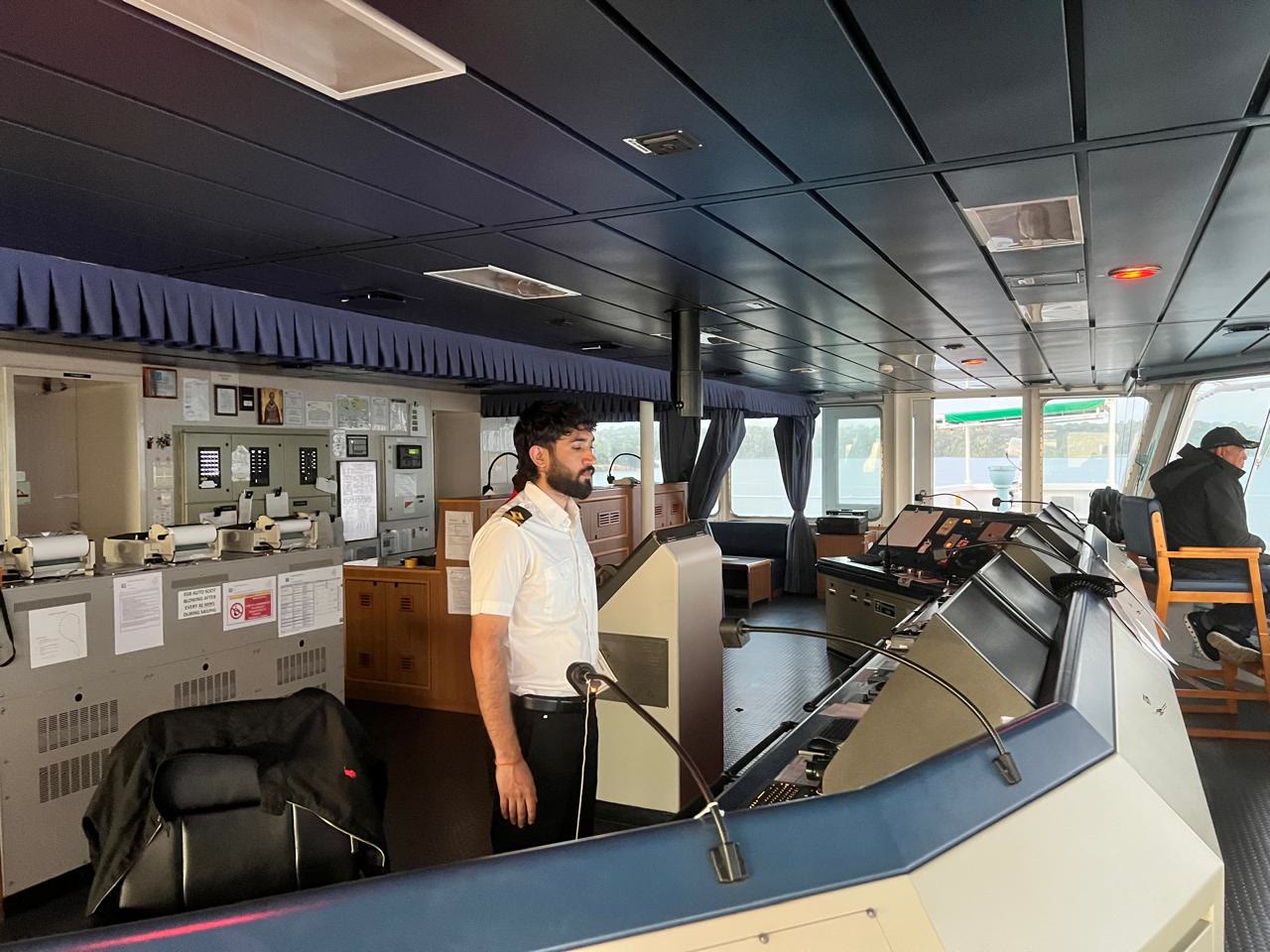 A deck officer on watch on the bridge of a merchant ship