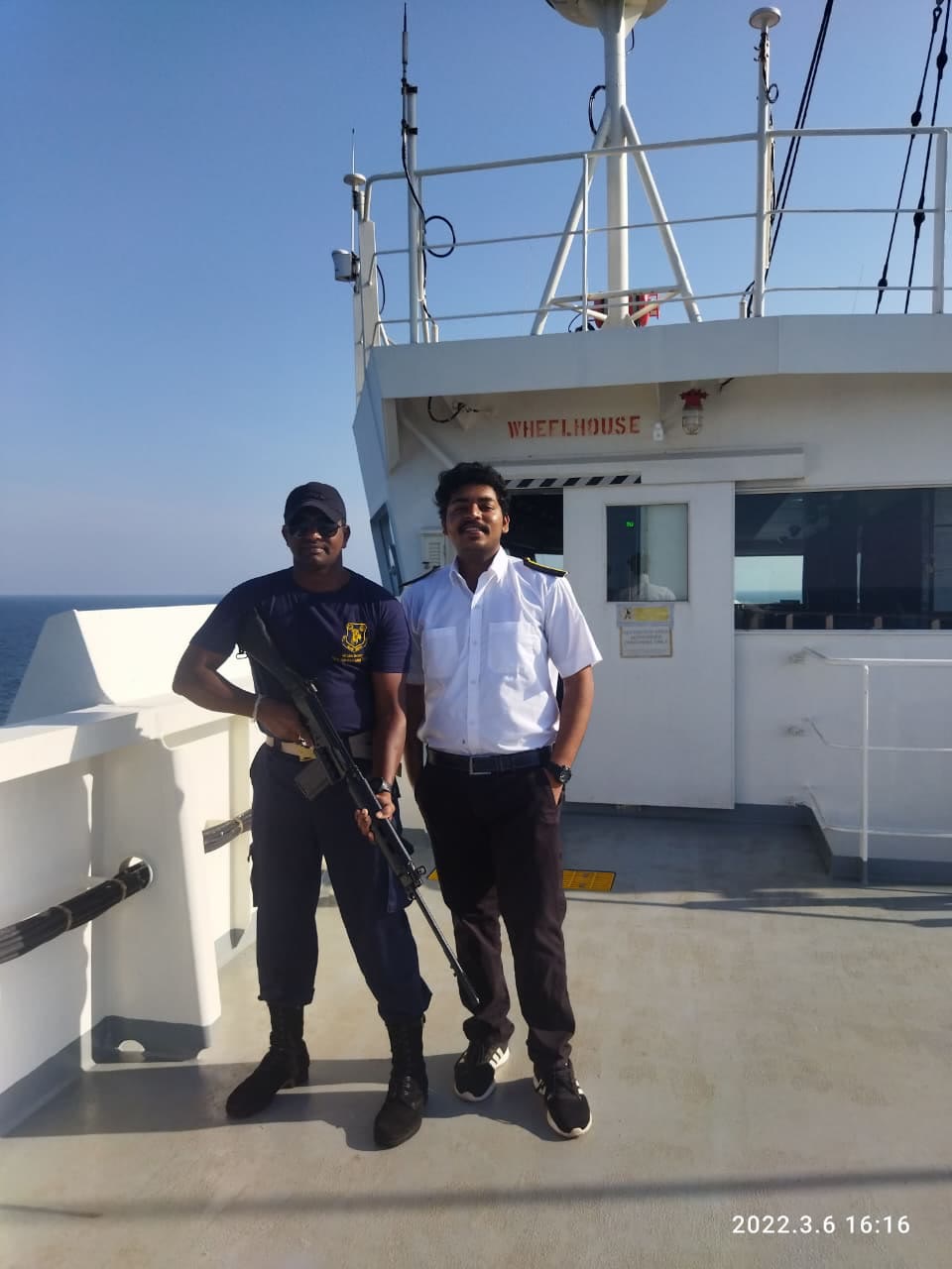 An officer at the wheelhouse console of a merchant ship