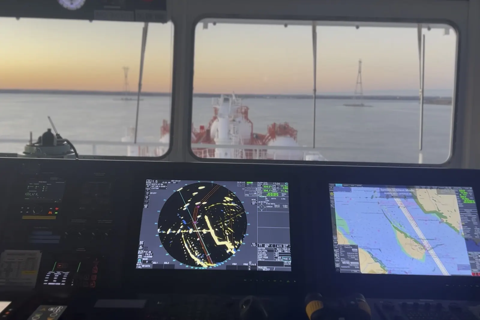 Dawn from a ship's bridge, radar and electronic chart in front